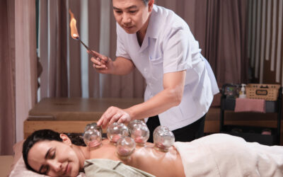Asian physical therapist treated Latino woman with cupping at a spa clinic.