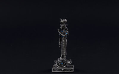 a figurine of a pharaoh on a black background