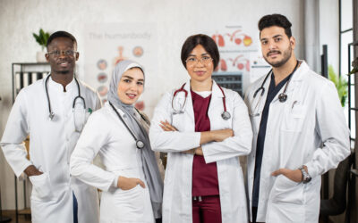 Team of four female and male multiracial doctors posing indoors