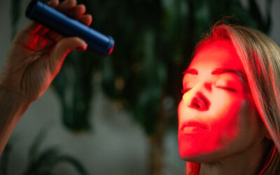 Woman using a red light therapy known for boosting collagen, reducing wrinkles, and improving skin tone through LED light technology in a skincare routine.