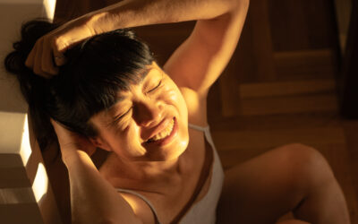 Asian woman enjoying warm sunlight indoors