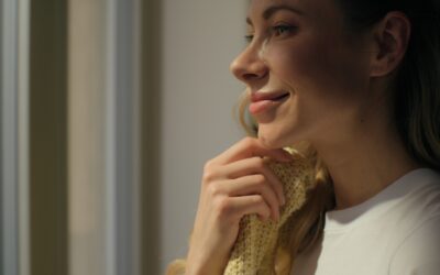 Happy relaxed woman enjoying cozy warm morning drinking coffee looking window at home Caucasian female girl homeowner looking drink beverage tea breakfast touching soft clothes relaxation tranquility