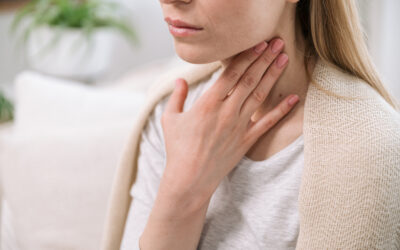 sick woman feeling throat sore and touching her neck