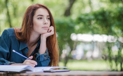 girl-lying-table-park-writing